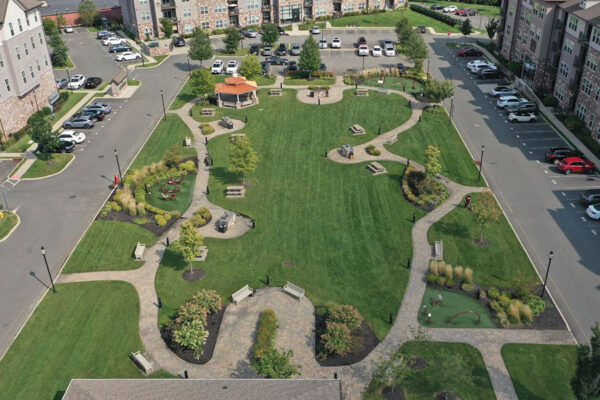 A beautifully maintained park nestled within a vibrant apartment complex.