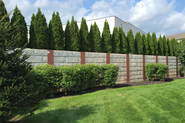 Neatly trimmed trees and shrubs lining the wall of the commercial property