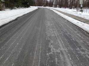Road or pavement cleared of snow. Clearing of snow from driveways and sidewalks is the responsibility of the business owner.