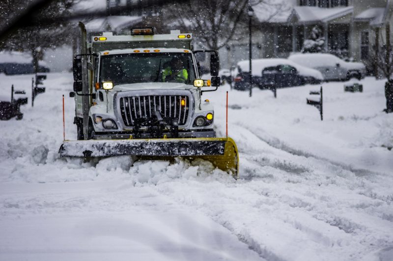 Truck plowing the snow on the road. In event assessment of the work can be conducted by third party audit and strictly adhering to these standards can lead to potentially reduced insurance premiums and lessen waste involved with slip and fall litigation.