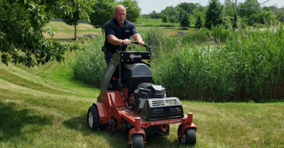 Landscaper mowing lawn
