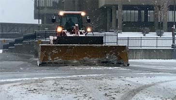 Plowing snow on commercial properties concept image for snow management